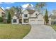 Charming two-story home with a manicured lawn and a two-car garage at 5485 Woodrun Ln, Johns Creek, GA 30005
