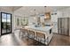 Open kitchen featuring a large center island with seating, stainless steel appliances, and custom cabinetry at 5485 Woodrun Ln, Johns Creek, GA 30005