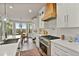 Gourmet kitchen featuring high-end appliances and a breakfast nook with scenic views at 5485 Woodrun Ln, Johns Creek, GA 30005