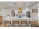 Bright kitchen features a large center island with seating, modern stainless steel appliances, and custom cabinetry at 5485 Woodrun Ln, Johns Creek, GA 30005