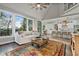 Open-concept living room featuring a fireplace, vaulted ceilings, and large windows at 5485 Woodrun Ln, Johns Creek, GA 30005