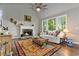 Cozy living room featuring a stone fireplace, vaulted ceilings, and large windows at 5485 Woodrun Ln, Johns Creek, GA 30005