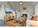 Cozy living room with a fireplace, hardwood floors, and ample natural light at 5485 Woodrun Ln, Johns Creek, GA 30005