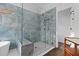 This luxurious bathroom features beautiful blue tile, glass shower, and modern fixtures at 5485 Woodrun Ln, Johns Creek, GA 30005