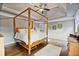 Spacious main bedroom features a four poster bed, ceiling fan, and hardwood floors at 5485 Woodrun Ln, Johns Creek, GA 30005