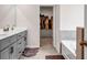 Bright bathroom featuring a double vanity, walk-in closet and a soaking tub at 787 Milo Bay Street, Loganville, GA 30052