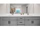 Bathroom featuring a double vanity with gray cabinets, quartz countertops, and modern fixtures at 787 Milo Bay Street, Loganville, GA 30052