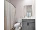 Bathroom with a gray vanity, white sink, toilet, and a shower curtain at 787 Milo Bay Street, Loganville, GA 30052