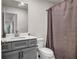Bathroom featuring a gray vanity with a white countertop and a shower with a brown curtain at 787 Milo Bay Street, Loganville, GA 30052