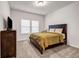 Comfortable bedroom with a large bed, dresser, plush carpeting, and two bright windows at 787 Milo Bay Street, Loganville, GA 30052