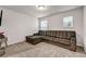 Bedroom with a sectional sofa, carpeted floor, and natural light at 787 Milo Bay Street, Loganville, GA 30052
