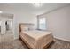 Bedroom featuring a large bed with a patterned comforter and a view into the hallway at 787 Milo Bay Street, Loganville, GA 30052