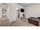 View of spacious bedroom with cozy carpet flooring and a walk-in closet adjacent to the laundry room at 787 Milo Bay Street, Loganville, GA 30052