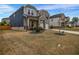 A charming two-story home with a mix of siding and brick, complemented by a well-kept lawn at 787 Milo Bay Street, Loganville, GA 30052