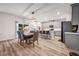 Open kitchen featuring gray cabinets, a center island, and seamless integration with the dining area at 787 Milo Bay Street, Loganville, GA 30052
