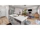 Bright and open kitchen featuring an island with white countertops and stainless steel dishwasher at 787 Milo Bay Street, Loganville, GA 30052