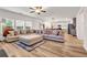 Expansive living room with a large sectional sofa, open to the kitchen and dining area at 787 Milo Bay Street, Loganville, GA 30052