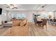 Spacious living room with wood floors, a comfortable sectional sofa, and access to the dining area at 787 Milo Bay Street, Loganville, GA 30052