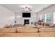Comfortable living room with a fireplace and large sectional sofa for relaxation and entertaining at 787 Milo Bay Street, Loganville, GA 30052