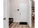 Practical mud room with shoe rack, door and wood-look flooring offers organization as you enter the home at 787 Milo Bay Street, Loganville, GA 30052