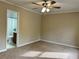 Well-lit bedroom with a ceiling fan, carpet, and an attached bathroom at 908 Chippendale Ln, Norcross, GA 30093