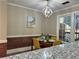 Stylish dining room with brick accent wall and modern lighting at 908 Chippendale Ln, Norcross, GA 30093