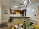 Open kitchen featuring granite countertops, wooden cabinets, a stylish chandelier and wood-look floors at 908 Chippendale Ln, Norcross, GA 30093