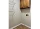 Practical laundry room with overhead cabinets, new floors and washer/dryer hookups at 908 Chippendale Ln, Norcross, GA 30093