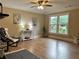 Sunlit living room featuring hardwood floors, fireplace, and large windows offering scenic views at 908 Chippendale Ln, Norcross, GA 30093