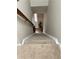Carpeted staircase leading to the main floor with a neutral-colored ceiling at 908 Chippendale Ln, Norcross, GA 30093