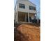 Modern two-story home with a light exterior, dark accents, and a unique elevated design, creating an inviting curb appeal at 996 Camilla St, Atlanta, GA 30314