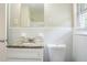 Well-lit bathroom featuring a granite-topped vanity and a white toilet at 1973 Columbia Dr, Decatur, GA 30032