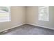 Cozy bedroom with neutral walls, plush carpet, and natural light from two windows at 1973 Columbia Dr, Decatur, GA 30032