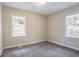 Bedroom featuring neutral walls, plush carpet, and natural light from two windows at 1973 Columbia Dr, Decatur, GA 30032