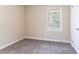 Bedroom with neutral walls, plush carpet, and natural light streaming through the window at 1973 Columbia Dr, Decatur, GA 30032