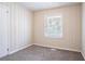 Bedroom featuring vertical cladding, neutral walls, plush carpet, and natural light at 1973 Columbia Dr, Decatur, GA 30032