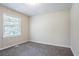 Bedroom with vertical cladding, neutral walls, plush carpet, and natural light at 1973 Columbia Dr, Decatur, GA 30032