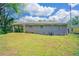 Exterior view of the house showing the backyard and a covered parking area at 1973 Columbia Dr, Decatur, GA 30032