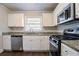 Modern kitchen with stainless steel appliances, granite countertops, and white cabinetry at 1973 Columbia Dr, Decatur, GA 30032
