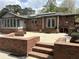 Expansive backyard featuring a brick patio with furniture, plus solar panels on the roof at 2112 Fisher Ne Trl, Atlanta, GA 30345