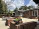 Extensive brick patio with pool, greenery, and well-manicured landscape at 2112 Fisher Ne Trl, Atlanta, GA 30345