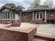 Brick backyard with patio and solar panels on the roof at 2112 Fisher Ne Trl, Atlanta, GA 30345