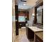 Classic bathroom with a granite vanity, stylish mirror, and neutral tiled flooring at 2112 Fisher Ne Trl, Atlanta, GA 30345