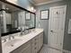 Modern bathroom with dual sinks, white cabinets, and black and white patterned floor at 2112 Fisher Ne Trl, Atlanta, GA 30345