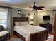 Cozy bedroom with ceiling fan, hardwood floors, TV, and plenty of natural light at 2112 Fisher Ne Trl, Atlanta, GA 30345