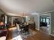 Sunlit dining room featuring a large table, hardwood floors, and access to the living room at 2112 Fisher Ne Trl, Atlanta, GA 30345