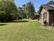 Expansive front yard featuring mature trees, lush lawn, and beautiful landscaping, enhancing curb appeal at 2112 Fisher Ne Trl, Atlanta, GA 30345