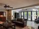 Bright living room boasting a ceiling fan, hardwood floors, and a wall of windows at 2112 Fisher Ne Trl, Atlanta, GA 30345