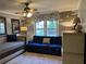 Comfortable living room with a large blue sofa, bright windows, and a decorative ceiling fan at 2112 Fisher Ne Trl, Atlanta, GA 30345