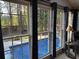 Inviting sunroom with a view of the pool, large windows, and blue curtains at 2112 Fisher Ne Trl, Atlanta, GA 30345